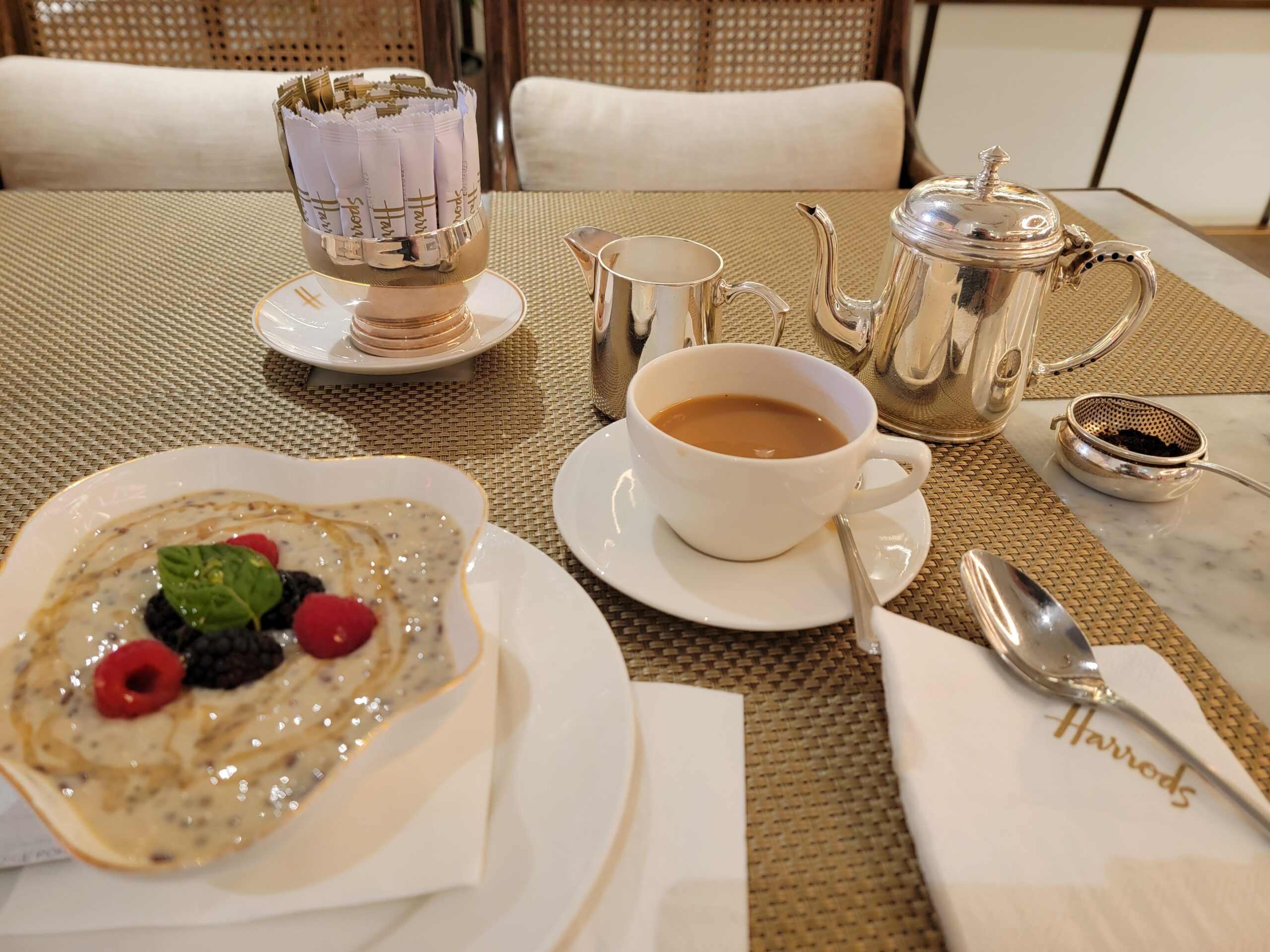 Elegant breakfast setup at Harrods Tea Room in Hamad International Airport, featuring chia pudding, tea, and silver service—highlighting the best of Qatar’s luxury dining.