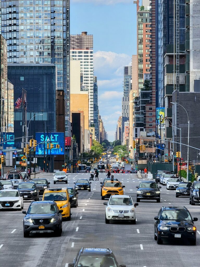 Busy NYC Street scene with yellow taxis, tall buildings, and American flags—capturing the vibrant pulse of urban life.
